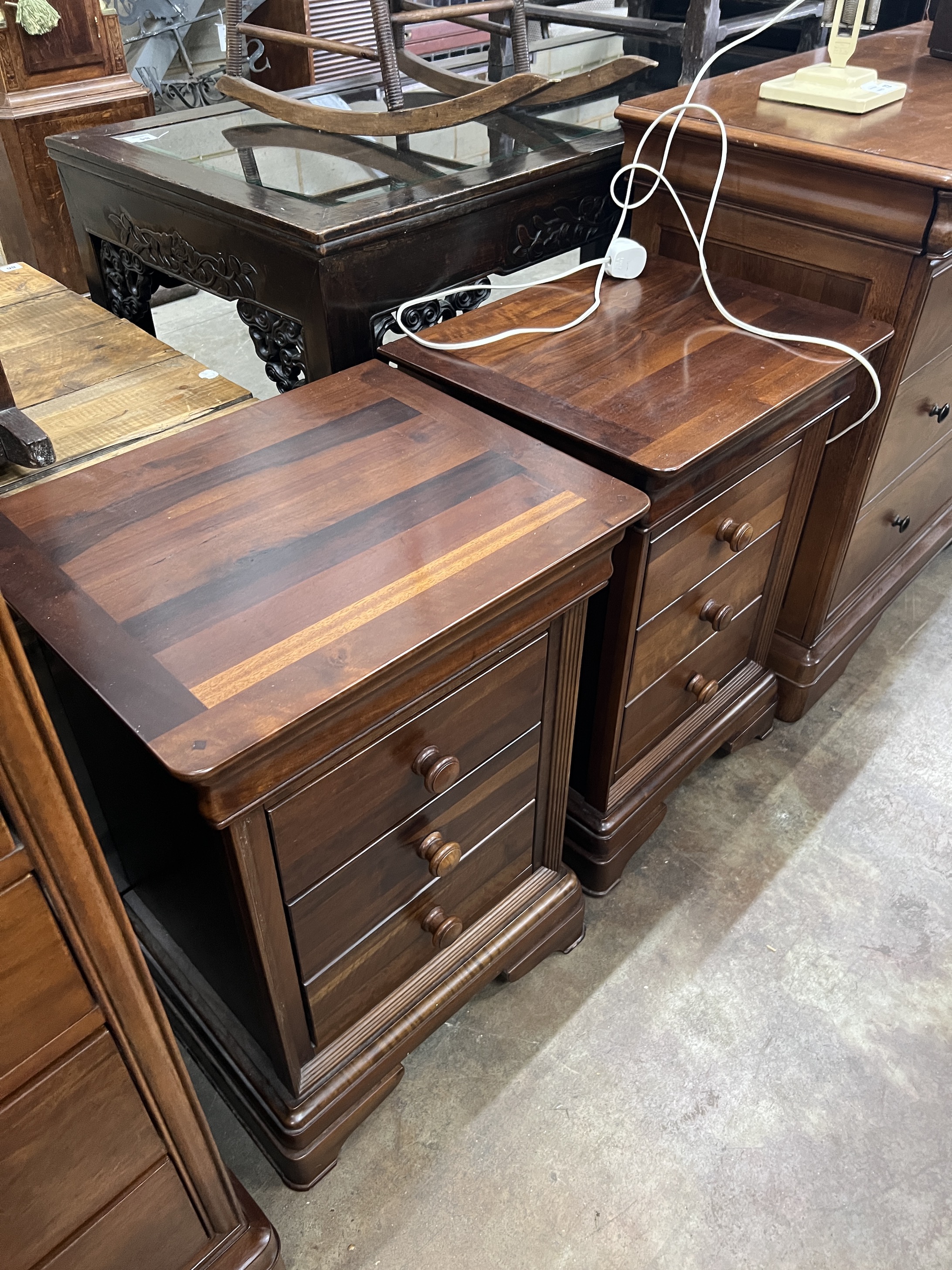 A contemporary five piece French mahogany bedroom suite, comprising sleigh bed, width 190cm, length 220cm, height 102cm (missing some bolts), a six drawer tall chest, three drawer chest and a pair of bedside chests